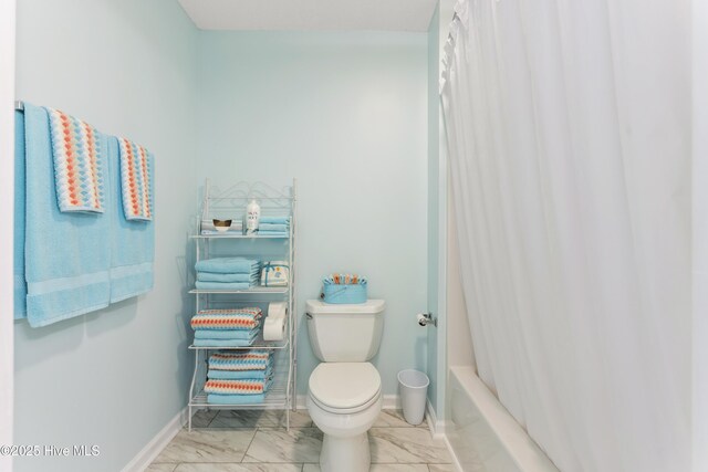 bathroom with baseboards, toilet, marble finish floor, and shower / bath combination with curtain