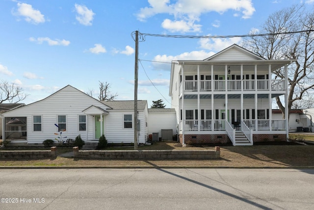 view of front of property with a porch, crawl space, cooling unit, and a balcony