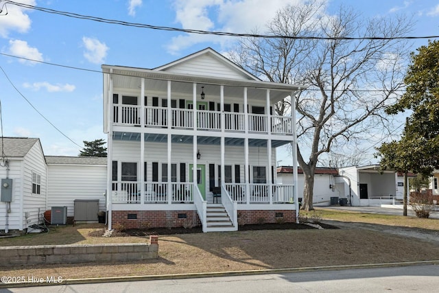 view of front of property featuring crawl space, covered porch, a balcony, and central AC