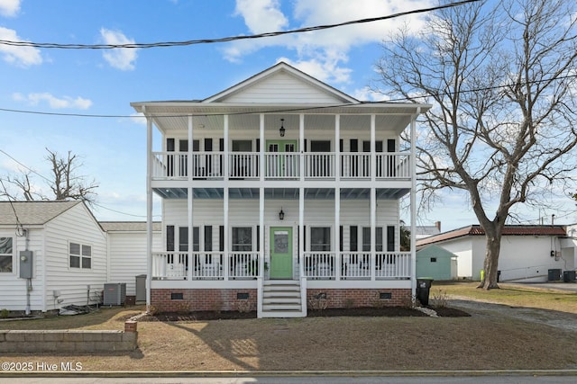 view of front of property featuring crawl space, a balcony, central AC unit, and a porch