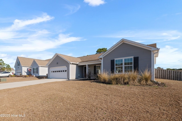 single story home with an attached garage, driveway, and fence