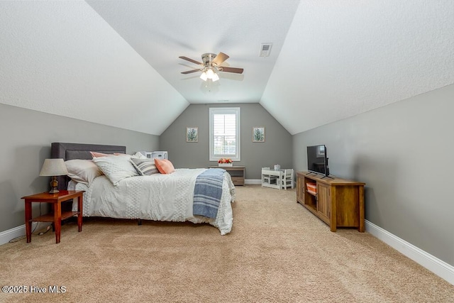bedroom with ceiling fan, light colored carpet, baseboards, vaulted ceiling, and visible vents