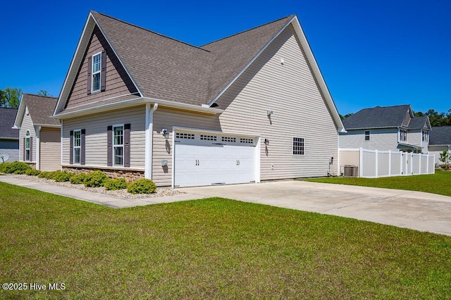 view of home's exterior featuring fence, roof with shingles, central AC unit, concrete driveway, and a yard