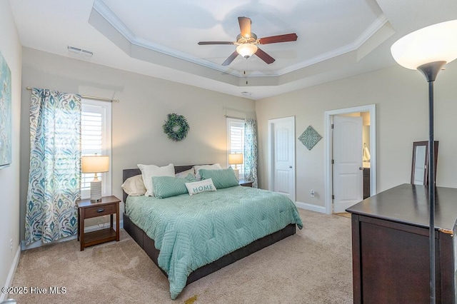 bedroom featuring crown molding, a raised ceiling, visible vents, and light colored carpet