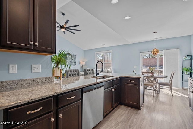 kitchen with stainless steel dishwasher, a sink, dark brown cabinetry, and light wood-style floors