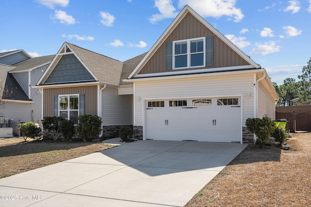 craftsman house with a shingled roof, an attached garage, board and batten siding, stone siding, and driveway