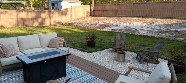 wooden deck with outdoor lounge area and a fenced backyard