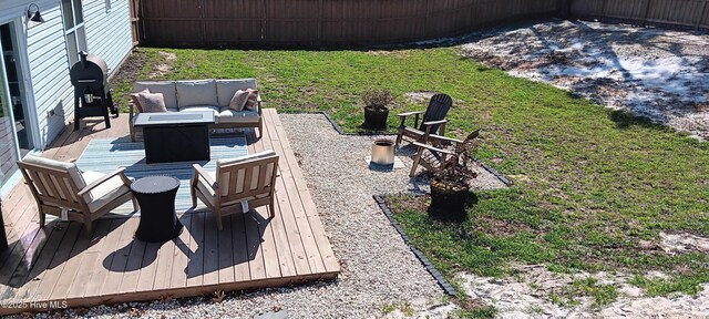 view of patio featuring a fenced backyard, grilling area, and a wooden deck