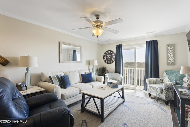 living area featuring ornamental molding, visible vents, and ceiling fan