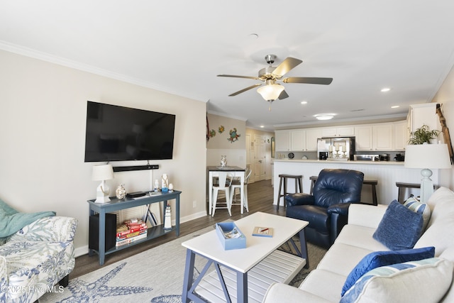 living room with recessed lighting, wood finished floors, a ceiling fan, baseboards, and crown molding