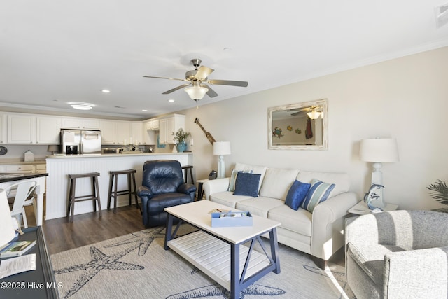 living room with ceiling fan, recessed lighting, wood finished floors, and crown molding