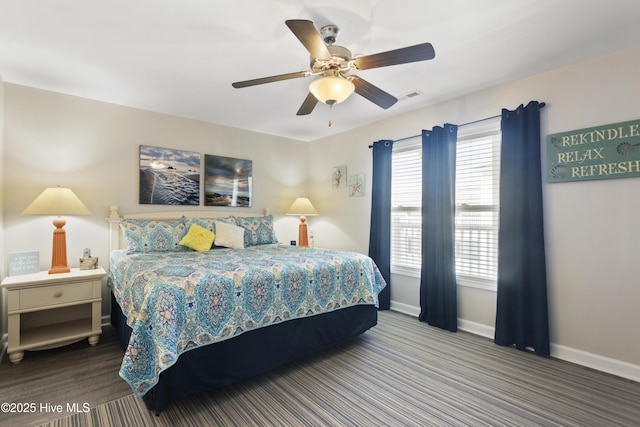 bedroom featuring a ceiling fan, visible vents, and baseboards