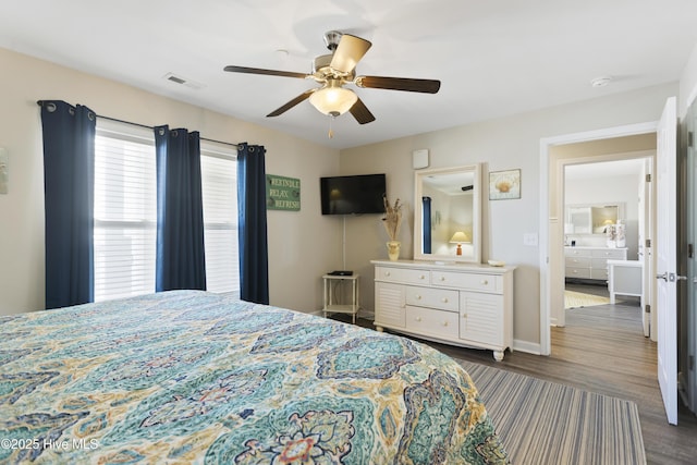 bedroom featuring ceiling fan, wood finished floors, visible vents, and baseboards