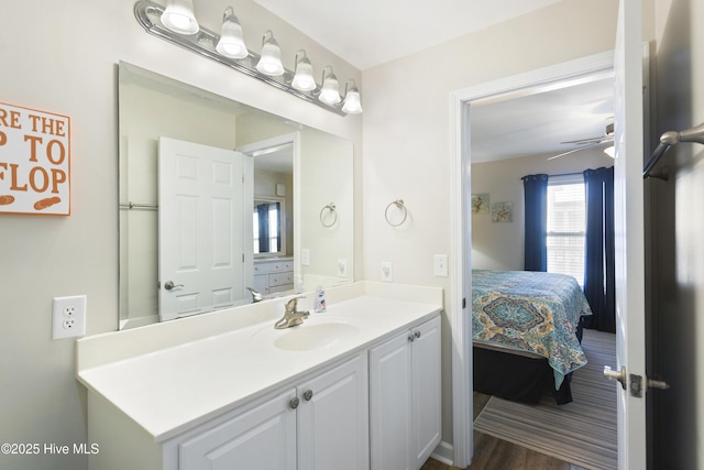 bathroom featuring a ceiling fan, vanity, ensuite bath, and wood finished floors