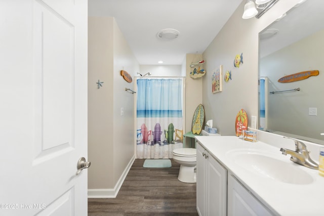 bathroom featuring baseboards, toilet, shower / tub combo with curtain, wood finished floors, and vanity