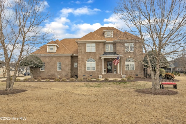 view of front of house with crawl space, a shingled roof, a front lawn, and brick siding