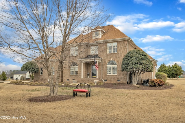 view of front of property featuring crawl space, a shingled roof, a front yard, and brick siding