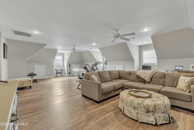 living room with recessed lighting, a ceiling fan, visible vents, vaulted ceiling, and light wood-type flooring