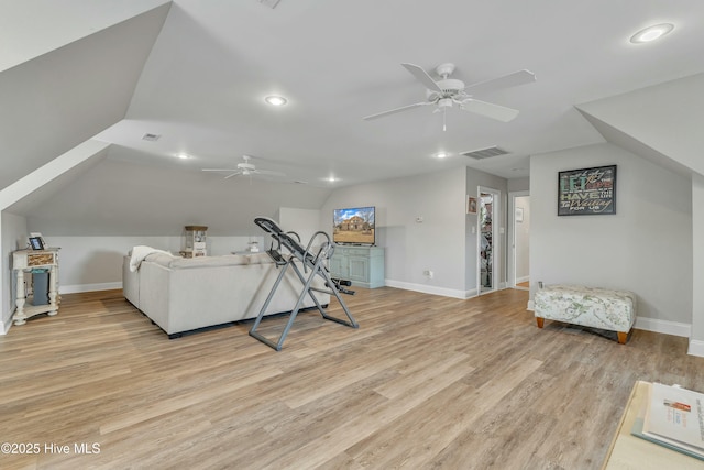 interior space featuring lofted ceiling, light wood finished floors, visible vents, and baseboards