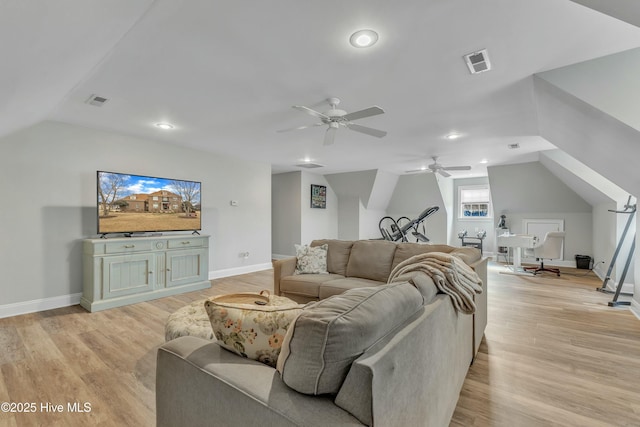 living room featuring lofted ceiling, light wood-style floors, baseboards, and visible vents