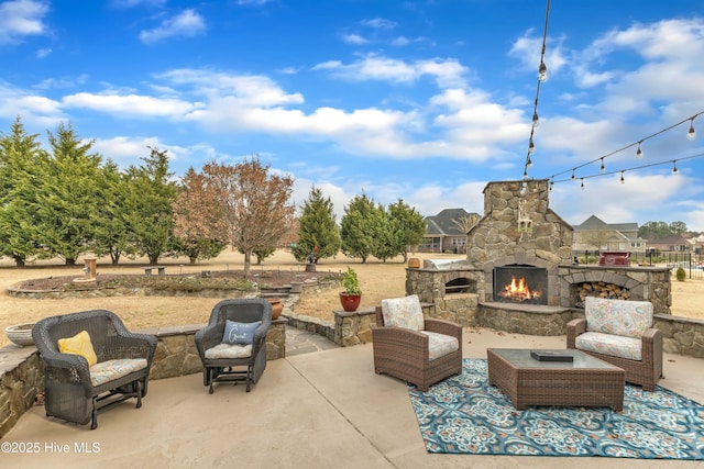 view of patio / terrace with an outdoor living space with a fireplace