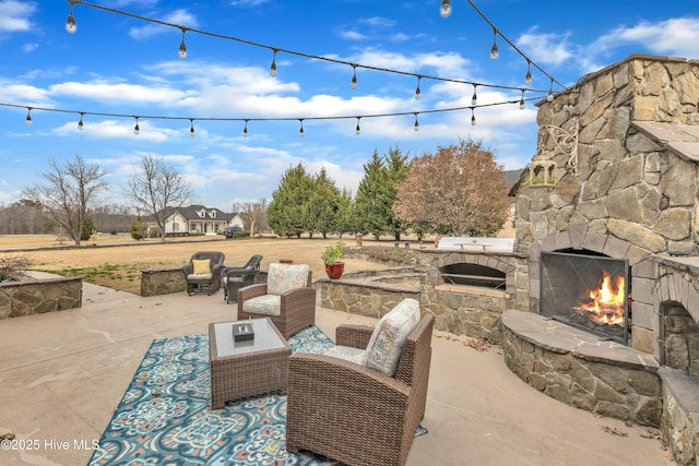 view of patio with an outdoor living space with a fireplace