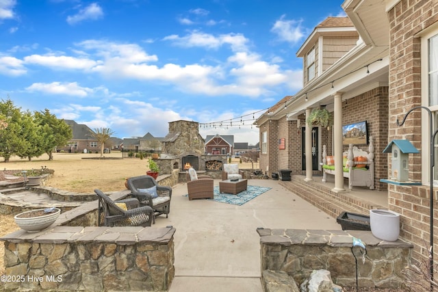 view of patio featuring an outdoor living space with a fireplace