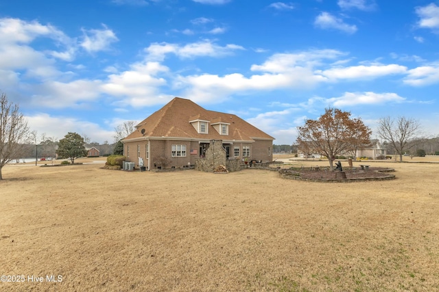 view of front of home featuring central AC and brick siding