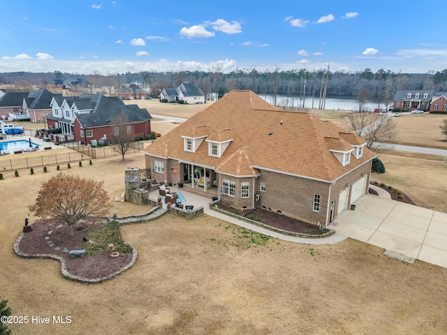 bird's eye view with a water view and a residential view