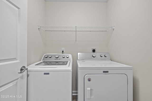 washroom featuring laundry area and washing machine and clothes dryer