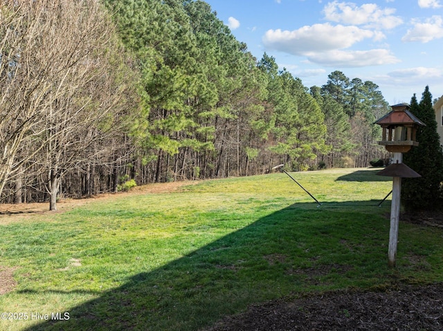 view of yard with a forest view