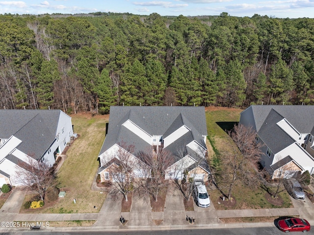 birds eye view of property with a wooded view