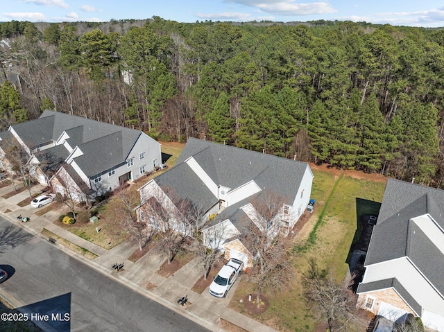 birds eye view of property with a wooded view