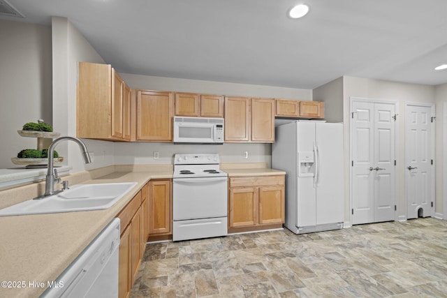 kitchen featuring white appliances, visible vents, light countertops, a sink, and recessed lighting