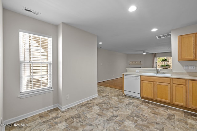 kitchen featuring a sink, baseboards, visible vents, and dishwasher