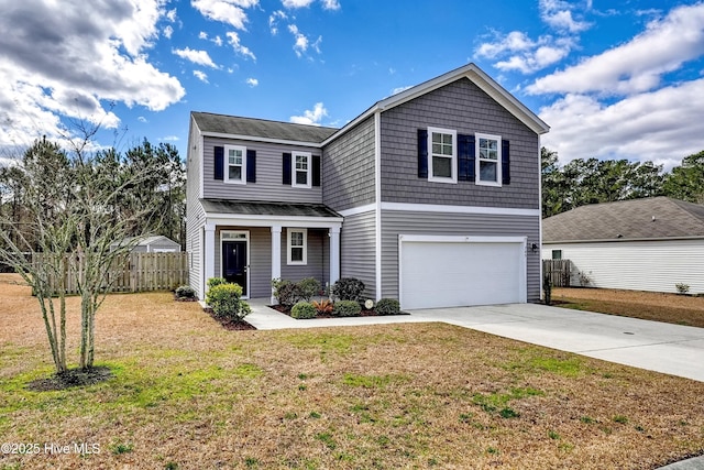 traditional-style house with a garage, covered porch, fence, driveway, and a front yard