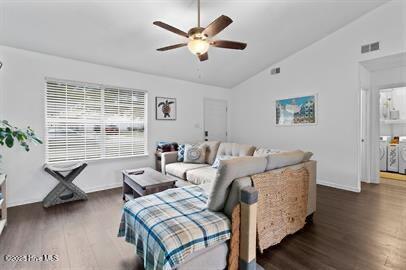 living room featuring ceiling fan, visible vents, vaulted ceiling, and wood finished floors