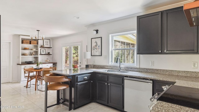 kitchen featuring dishwashing machine, ornamental molding, a sink, and a wealth of natural light