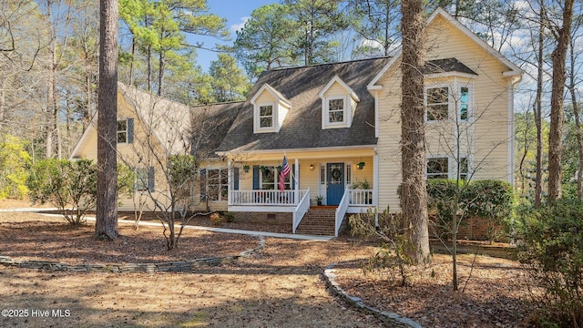 cape cod house featuring a shingled roof, covered porch, and crawl space