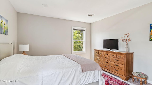 bedroom with visible vents and carpet flooring