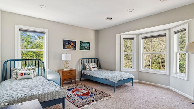 carpeted bedroom featuring baseboards and visible vents