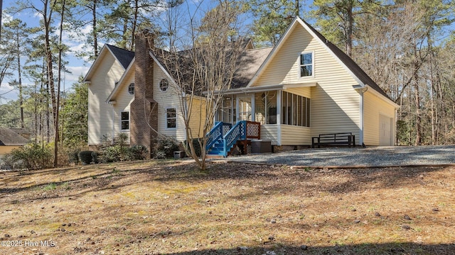 view of front of property featuring a chimney and cooling unit