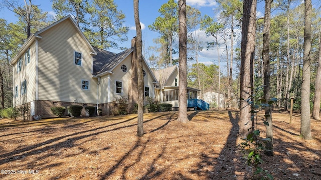 view of side of home featuring crawl space
