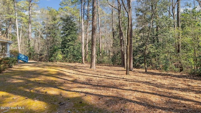 view of yard featuring a view of trees
