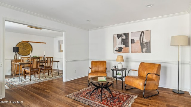 sitting room with baseboards, ornamental molding, wood finished floors, and recessed lighting