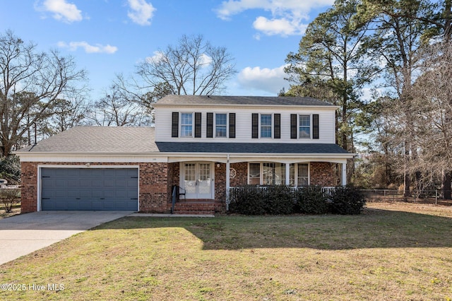 traditional home featuring brick siding, an attached garage, driveway, and a front yard