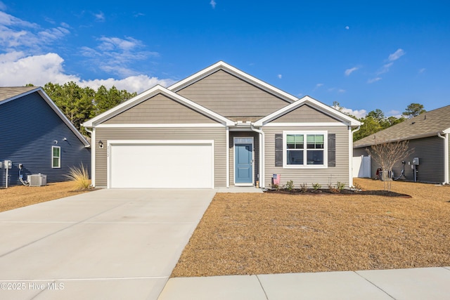 ranch-style house featuring a garage, a front yard, cooling unit, and driveway