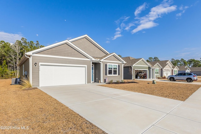 single story home with a garage, concrete driveway, and cooling unit