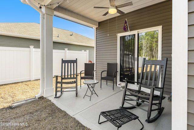 view of patio featuring fence and ceiling fan