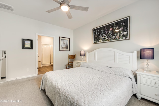 carpeted bedroom featuring a ceiling fan, visible vents, connected bathroom, and baseboards